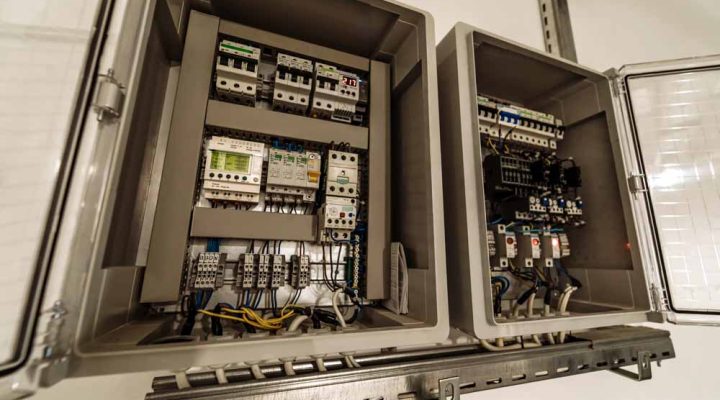An open electrical panel showcasing advanced circuit breakers, digital controls, and neatly organized wiring.