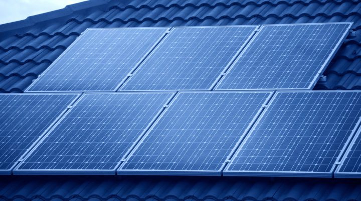 A row of solar panels installed on a tiled roof, harnessing renewable energy for sustainable power generation.